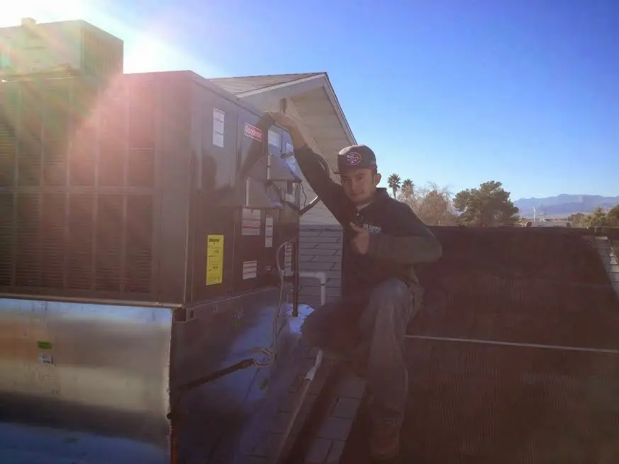 HVAC technician performing AC Tune-Up on a rooftop unit in Santaquin
